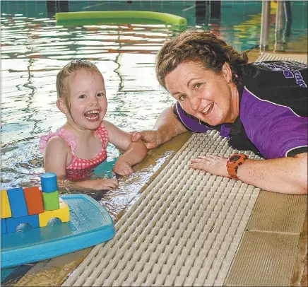  ??  ?? Austswim teacher Karen Martin teaching swimming and water safety to Chloe Brown. Karen says learning to swim is a family responsibi­lity – “you can’t rely on school swimming programs.” PHOTO: DARCEE NIXON