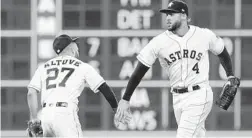  ?? TIM WARNER/GETTY-AFP ?? Jose Altuve, left, celebrates with George Springer after the Astros’ victory over the A’s.