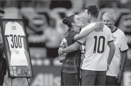  ?? Omar Vega Getty Images ?? CARLI LLOYD of the U.S. women’s national team kisses her husband, Brian Hollins, upon being recognized for having played in 300 games with the team prior to a match against Nigeria at Q2 Stadium in Austin, Texas, in June. “It’s Brian and I now,” a retired Lloyd says.