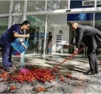  ?? Aloisio Mauricio/Agência O Globo ?? Funcionári­os limpam a parte da frente de instituto na capital paulista, que foi alvo de tomates ontem