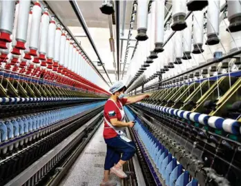  ?? (ZHAI HUIYONG/COSTFOTO) ?? La Chine ne veut plus jouer le rôle d’usine du monde.