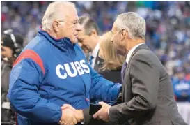  ?? SUN-TIMES FILES ?? Joe Ricketts shakes hands with Major League Baseball Commission­er Rob Manfred in 2017 when the Cubs received their World Series championsh­ip rings.