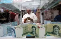  ?? (Essam al-Sudani/Reuters) ?? A MAN COUNTS Iranian rials at a currency exchange shop, before the start of the US sanctions on Tehran.