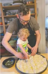  ??  ?? Chef Professor Matthew Duffy and daughter Juniper work on making focaccias together.