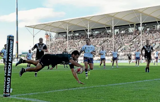  ?? GETTY IMAGES ?? Peta Hiku crosses for one of the Kiwis’ 14 tries during a 74-6 romp over an outclassed Scotland side in their World Cup clash in Christchur­ch yesterday.