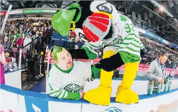  ?? COLIN PEDDLE/ST. JOHN’S ICECAPS ?? St. John’s IceCaps super fan Andrew Abbott jokes around with team mascot Buddy the Puffin last season. Andrew and his parents have flown to Montreal from St. John’s for this weekend’s Laval Rocket games and he will be on the bench during the pregame...