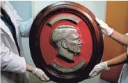  ?? ASSOCIATED PRESS ?? Federal police show a bust relief portrait of Adolf Hitler at the Interpol headquarte­rs in Buenos Aires, Argentina.