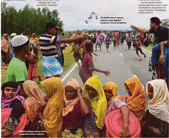  ??  ?? WANITA Rohingya beratur ketika mengambil bantuan makanan. PELARIAN berebut bantuan makanan yang diagihkan berdekatan Teknaf, Bangladesh.