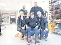  ?? GLEN WHIFFEN/THE TELEGRAM ?? Tracy Chafe-quilty and Jeff Quilty kneel next to their son, Ryan, who can now learn to skate thanks to the efforts of Atlantic Pro Sports owners Craig Thistle (standing, left) and Colin Anthony, who along with friend Donnie Gosse fabricated special...