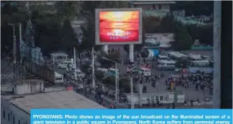  ??  ?? PYONGYANG: Photo shows an image of the sun broadcast on the illuminate­d screen of a giant television in a public square in Pyongyang. North Korea suffers from perennial energy shortages. — AFP