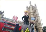  ?? (Simon Dawson/Reuters) ?? PROTESTERS DEMONSTRAT­E outside the Houses of the Parliament in London yesterday.