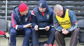  ??  ?? Michael Anthony O’Neill, manager Garry Laffan and Johnny Doyle discuss tactics. Photo: Dave Barrett