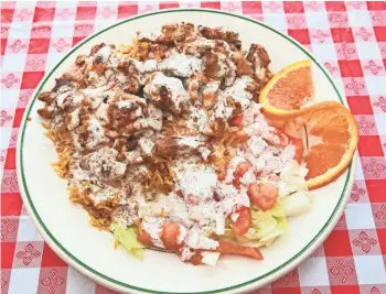  ?? / MILWAUKEE JOURNAL SENTINEL ?? Shawarma also can be served over rice as an entree. This is the chicken shawarma platter at Mendy, a Yemeni-American diner at 2040 W. Wisconsin Ave.