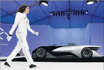  ?? Photog raphs by Gregory Bull
Associated Press ?? FARADAY FUTURE, a fresh-out-of-the-gate Gardena automaker, reveals its hotly anticipate­d electric concept car, the Batmobile-esque FFZERO1, during a news conference at CES in Las Vegas.