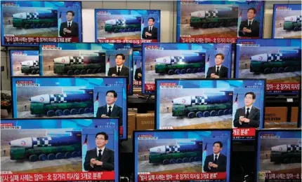  ?? AFP PHOTO ?? LINGERING THREAT
Television screens show a news report about Pyongyang’s latest missile launch, with file footage of a North Korean missile being paraded, at an electronic­s market in South Korea’s capital Seoul on Nov. 3, 2022. US President Joe Biden will seek ways to rein in Pyongyang after its barrage of missile tests in talks with South Korean and Japanese leaders on Sunday, Nov. 13, 2022, a day before a high-stakes encounter with China’s Xi Jinping.