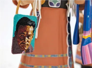  ??  ?? Detail of the beaded bag featuring a portrait of Lloyd Kiva New by Marcus Amerman (Choctaw Nation).