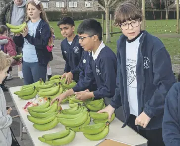  ?? ?? St Richard’s students handing out bananas for families and households to enjoy