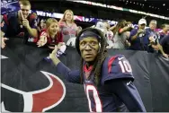  ?? MICHAEL WYKE — THE ASSOCIATED PRESS ?? Texans wide receiver DeAndre Hopkins celebrates with fans after aplayoff football game against the Bills in Houston.