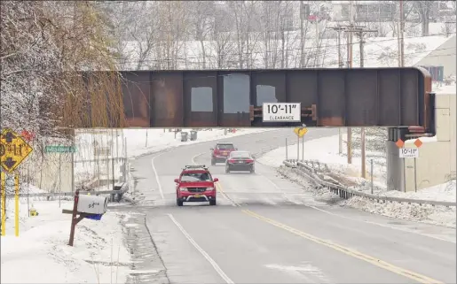  ?? Lori Van Buren / Times Union ?? The town of Glenville passed legislatio­n to fine drivers up to $450 for striking the low-slung trestle over Glenridge Road.