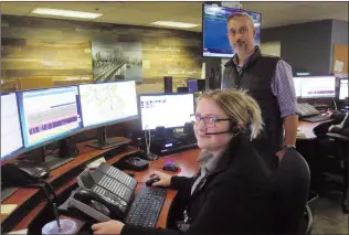  ?? NEWS PHOTO GILLIAN SLADE ?? The provincial government introduced news standards for 911 call centres to be achieved across the province. Pictured are 911 dispatcher Courtney Fortier and Simon Amos, the city's manager for community access.