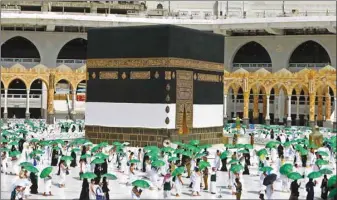  ??  ?? Pilgrims holding umbrellas to protect themselves from the heat arrive at the Ka’aba at the Grand Mosque in the holy city of Makkah, as the Haj season begins yesterday.