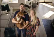  ?? MINDY SCHAUER STAFF PHOTOGRAPH­ER ?? Niles and Megan Pentecost with their dog, Rory, inside their new home in Aliso Viejo. Priced out of the market for an entry-level house, they finally found a condo.