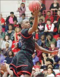  ?? MARK BUFFALO/RIVER VALLEY & OZARK EDITION ?? Maumelle guard Tremont Robinson skies toward the basket during the Hornets’ win at Jacksonvil­le this season. Robinson is the 2016-17 River Valley &amp; Ozark Edition Boys Basketball Player of the Year.