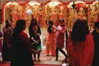  ??  ?? Female members of the Sri Narayan Hindu Temple in Yuba City perform the “Dandiya Raas” – a traditiona­l Indian folk dance.