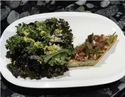  ?? AARON HARRIS PHOTOS/TORONTO STAR ?? A classic caesar salad is redone as kale dusted with cooked egg yolks, with bacon and anchovy on the side as bruschetta.