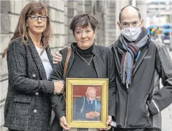  ?? PHOTO: COLLINS ?? Huge loss: Caroline Dillon, Ann Walsh and Gerard Dillon hold a picture of their late father, Patrick Dillon, outside the High Court yesterday.