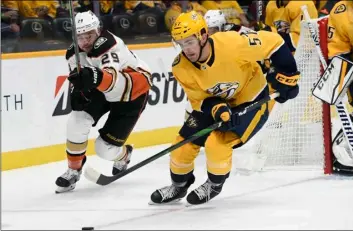  ?? aP PHOtO/Mark ZaleskI ?? Anaheim Ducks center Devin Shore (29) and Nashville Predators defenseman Dante Fabbro (57) chase the puck during the first period of an NHL hockey game on Tuesday in Nashville, Tenn.