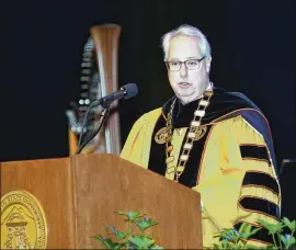  ?? REBECCA BREYER PHOTOS / SPECIAL ?? Kennesaw State University president Sam Olens speaks during the investitur­e ceremony at KSU on Thursday. He’s under fire for possible caving in to demands by Cobb County Sheriff Neil Warren and others to find a way to prevent cheerleade­rs from kneeling...