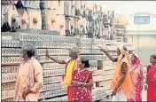  ?? HT FILE ?? Devotee go past constructi­on material for Ram temple in Ayodhya.