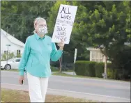  ?? LYNN KUTTER ENTERPRISE-LEADER ?? Kristine Hall of Prairie Grove said her mother marched with Martin Luther King Jr., 50 years ago. Hall participat­ed in a peaceful protest for racial justice in Prairie Grove on Saturday.