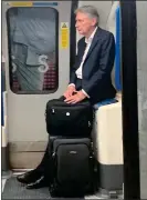  ??  ?? GLUM: Mr Hammond on the Tube