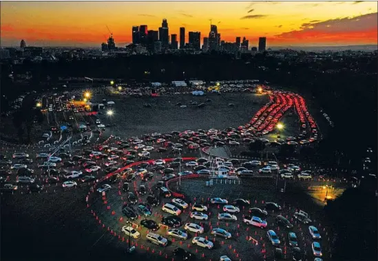  ?? Carolyn Cole Los Angeles Times ?? CARS LINED UP as Angelenos waited to get a Curative test for the coronaviru­s Jan. 4 at Dodger Stadium. The CARES Act required insurers to cover testing costs.