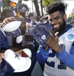  ?? ASSOCIATED PRESS FILE PHOTO ?? Dallas Cowboys running back Ezekiel Elliott signs autographs at training camp in Oxnard, Calif.