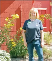  ?? CAROL ROLF/CONTRIBUTI­NG PHOTOGRAPH­ER ?? Debbie Guthrie, 2019 Faulkner County Master Gardener of the Year, poses near the flower beds on the campus of the Faulkner County Museum. The museum was the Master Gardeners’ Project of the Year.