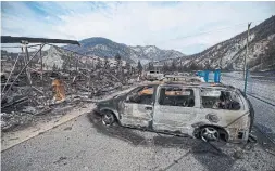  ?? DARRYL DYCK THE CANADIAN PRESS FILE PHOTO ?? The remains of a large structure and vehicles destroyed by the Lytton Creek wildfire are seen on the side of the Trans-Canada Highway near Lytton, B.C. Polls suggest climate change is a top concern for many people across the country.