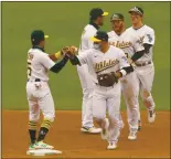  ?? ANDA CHU – STAFF PHOTOGRAPH­ER ?? Tony Kemp, left, and Ramón Laureano congratula­te each other following the A’s victory on Thursday.