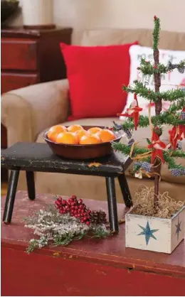  ??  ?? Left: Joined by a painted stool, a small vintagesty­le tree adds a festive touch on the child’s blanket chest that serves as a coffee table in the family room.