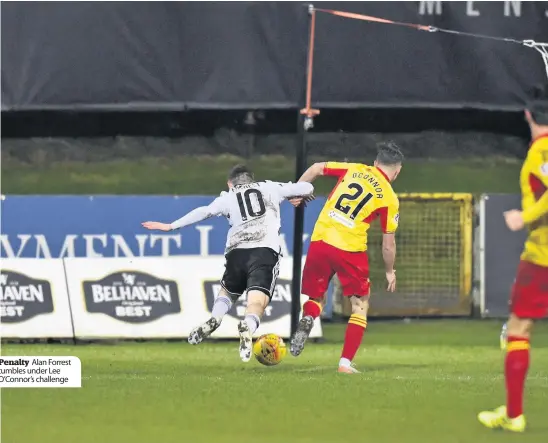  ??  ?? Penalty Alan Forrest tumbles under Lee O’Connor’s challenge