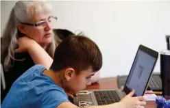  ?? Reuters ?? A 4th grader tries to figure out assignment instructio­ns as he navigates the online learning system at his home in Washington.