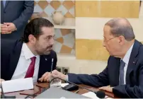  ?? AP ?? Lebanese President Michel Aoun, right, speaks with Saad Hariri, at the Presidenti­al Palace in Baabda, east of Beirut on Tuesday.—