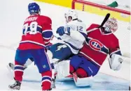  ?? PAUL CHIASSON/ THE CANADIAN PRESS ?? “We got the bounces we’ve lacked in the past week,” Carey Price said after Thursday night’s win. He was bumped by the Lightning’s Ryan Malone during the third period.