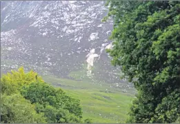  ??  ?? Keen golfer Allan Napier send us this picture taken at the weekend from Corrie golf course looking up to The Devils’ Punchbowl. He said: ‘A recent landslip seems to have left the impression of a golfer waving his golf club, as he celebrates sinking a putt. Can you spot him?’