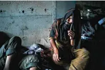  ?? ?? Afghans sit under a bridge to take drugs, mostly heroin and methamphet­amines, in Kabul.