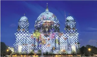  ?? O D D A N D E R S E N / A F P/ G E T T Y I MAG E S / F I L E S ?? Berlin Cathedral is colourfull­y illuminate­d during the Festival of Lights. Famous landmarks of the German capital are lit up for the annual festival.