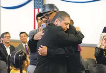  ?? NELVIN C. CEPEDA U-T ?? Mauricio Hernandez Mata (left) and Leonel Contreras embrace after taking the oath of citizenshi­p. Both formerly deported veterans were returned under the Immigrant Military Members and Veterans Initiative.
