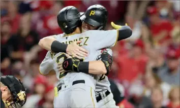  ?? Andy Lyons/Getty Images ?? The Pirates’ Endy Rodriguez, left, celebrates with Henry Davis after hitting a home run in the sixth inning Friday against the Reds in Cincinnati. Davis has been shoehorned into right field and Rodriguez, as a catcher, had had to learn on the fly with an entire pitching staff.